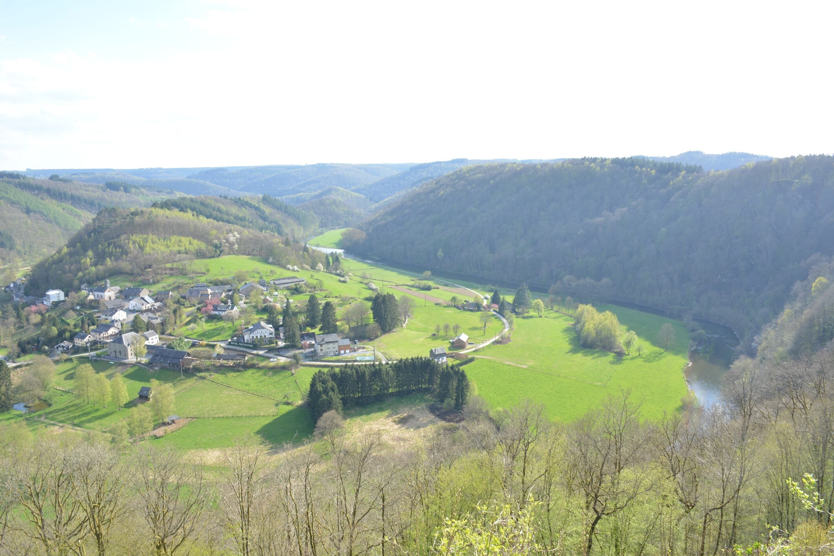 A valley with a river, houses, and a small town.
