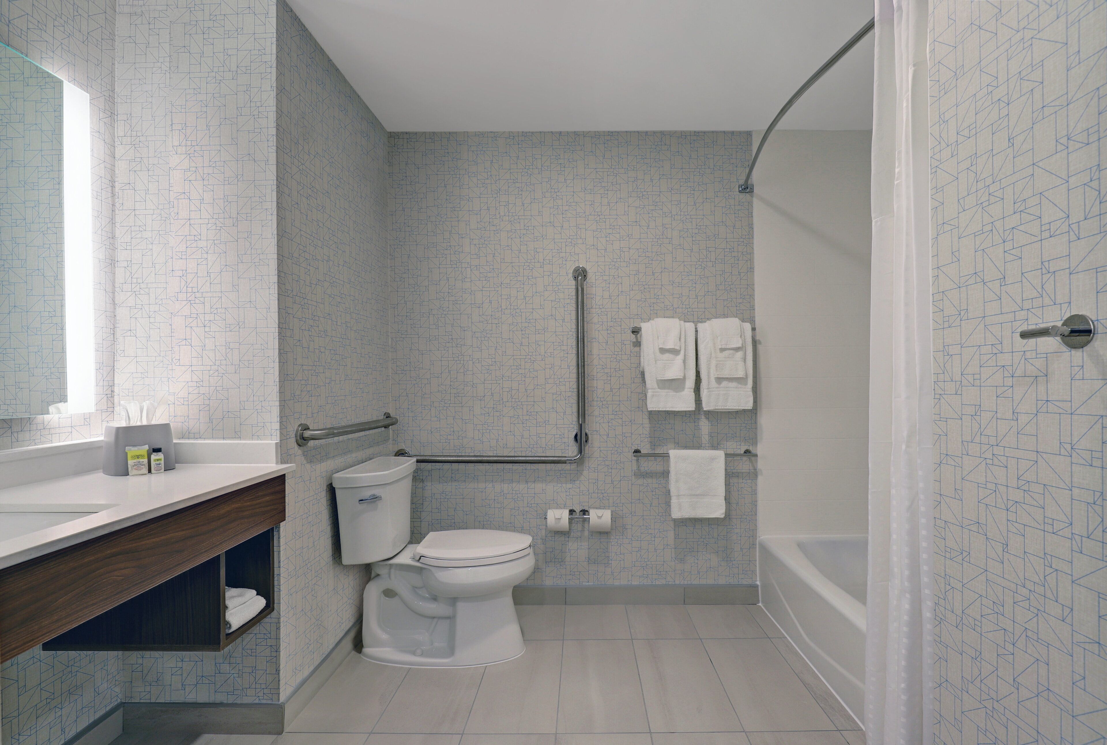 A modern bathroom with a toilet, bidet, and shower area.