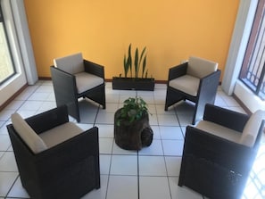 Relax in our welcoming lobby, featuring a cozy seating area with armchairs and a central coffee table.