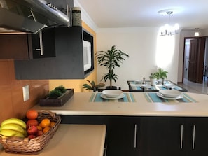 Enjoy cooking in this well-equipped kitchen with a central island, sink, and stainless steel range hood.