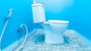 A bathroom with a toilet, a bidet, and a shower hose. - KoolKost @ Menceng Raya (Jakarta)