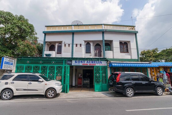 A building with a sign reading "KOST AURELIA" and a green gate. - RedDoorz Syariah near Stasiun Kereta Api Kisaran (West Kisaran)