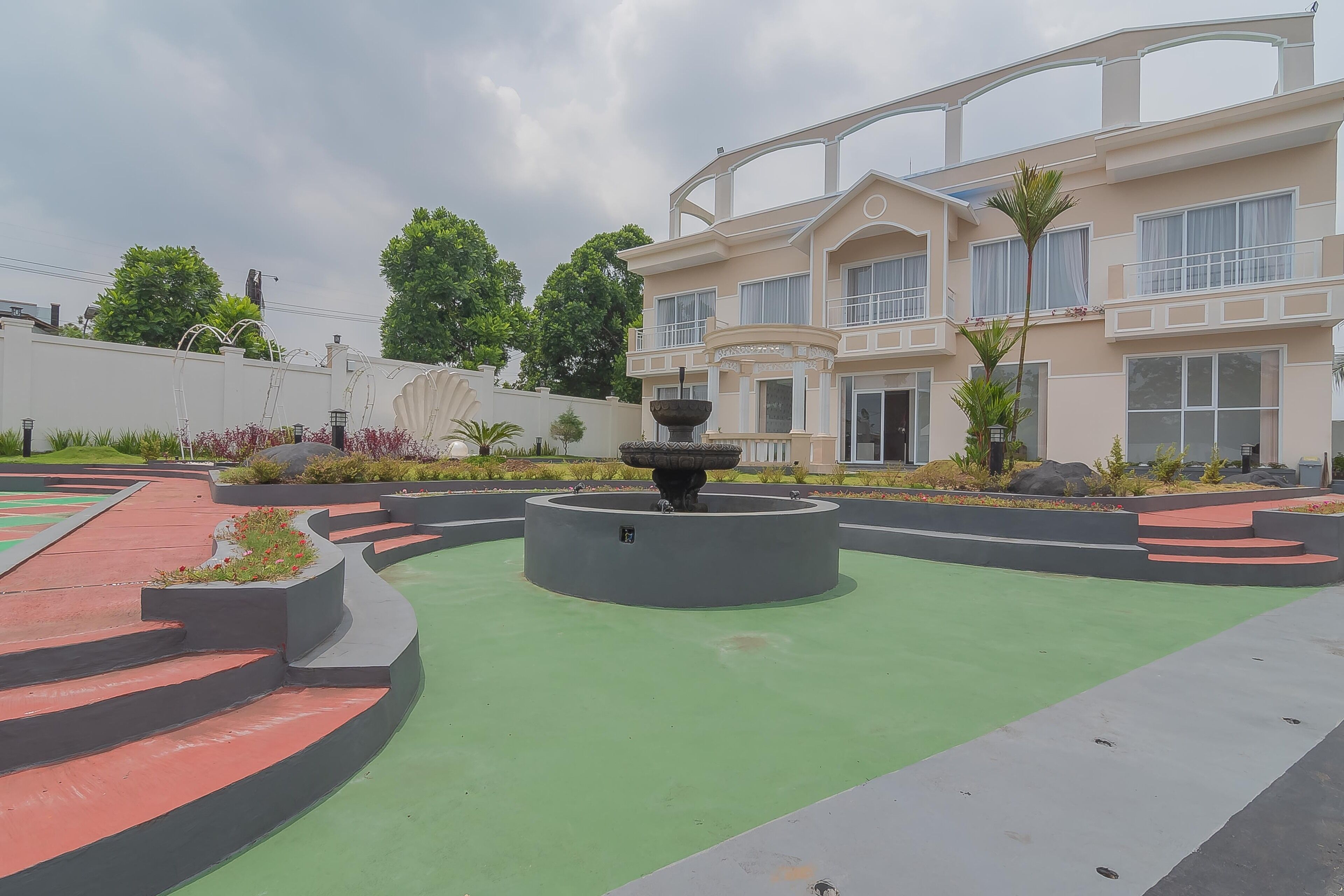 A modern building with a fountain in the courtyard.
