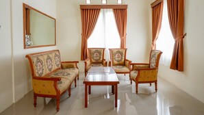 A living room with a sofa set, a coffee table, and curtains.