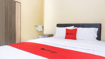 A hotel room with a bed, a wardrobe, and a nightstand.
