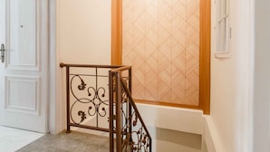 A staircase with a metal railing and a wooden trim. - RedDoorz Plus Syariah @ Jalan Dr Sutomo Padang (Padang)