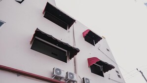A multi-story building with several air conditioning units mounted on the exterior wall. - RedDoorz @ Jalan Pangeran Antasari Lampung 2 (Bandar Lampung)