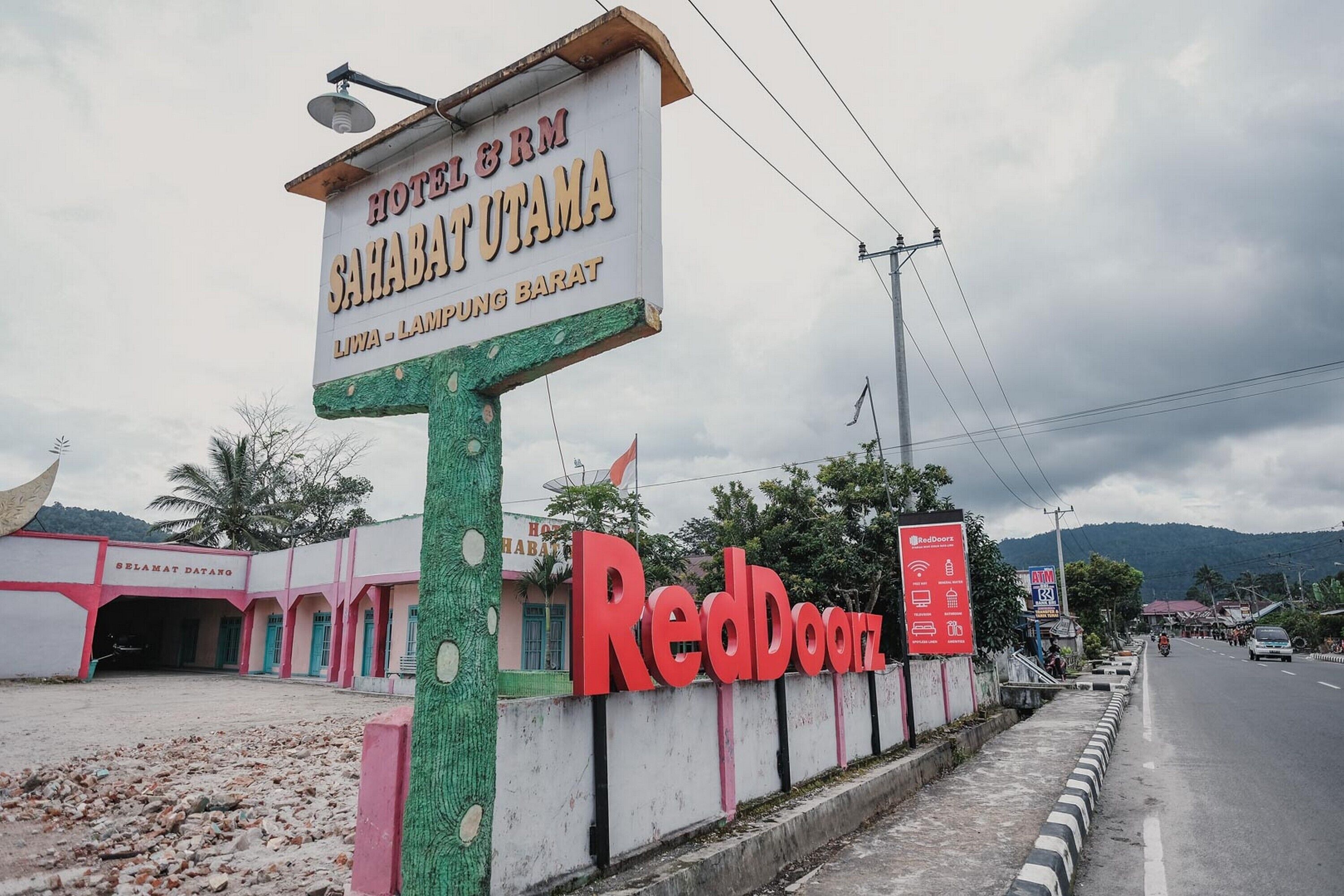 A hotel sign with "HOTEL & RM SAHABATUTAMA" and "LIWA - LAMPUNG BARAT" indicating its location.