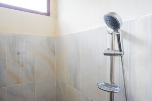 A shower with a handheld showerhead and a handheld basin in a tiled bathroom. - RedDoorz @ Makale Tana Toraja (Makale)