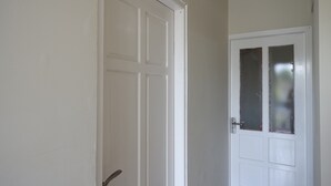 A white door with a glass panel and a door handle. - KoolKost Female Syariah near UII Taman Siswa (Yogyakarta)