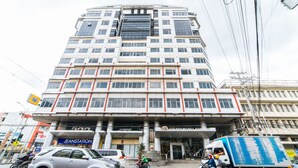 A multi-story building with a prominent entrance and signage for "GoldenMaida Hotel." - RedDoorz Plus @ E Rodriguez Corner Banawe (Quezon City)