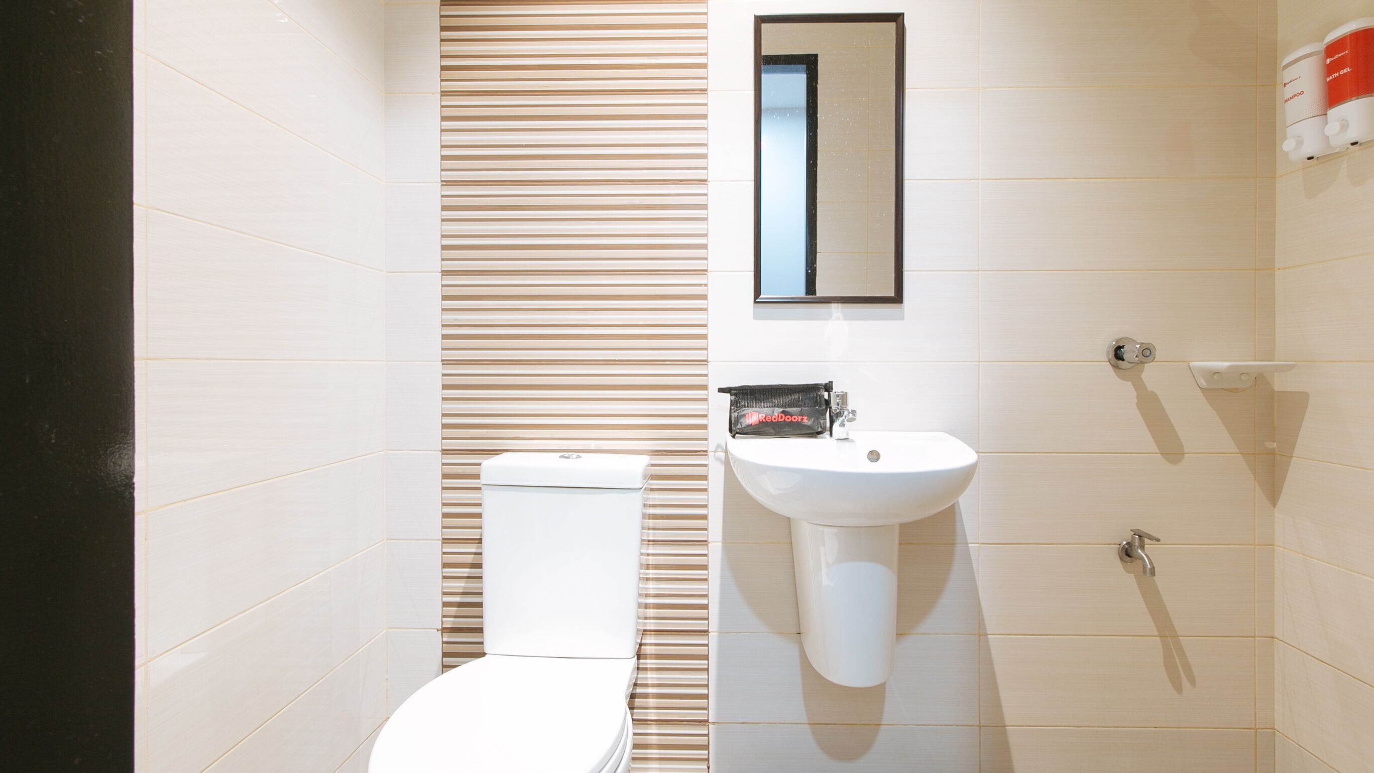 A modern bathroom with a toilet, sink, and shower.