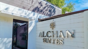 A building with a sign that reads "ALCHAN SUITES". - RedDoorz near Trade School Gensan (General Santos)