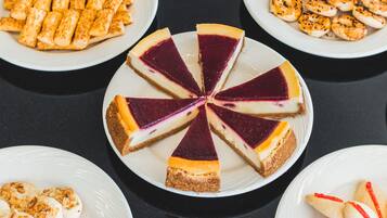 A dessert table with various types of cakes and pastries.