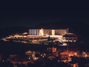 A multi-story hotel with a central courtyard, surrounded by smaller buildings. - Dalya Resort Aqua & Spa Hotel (Datça)