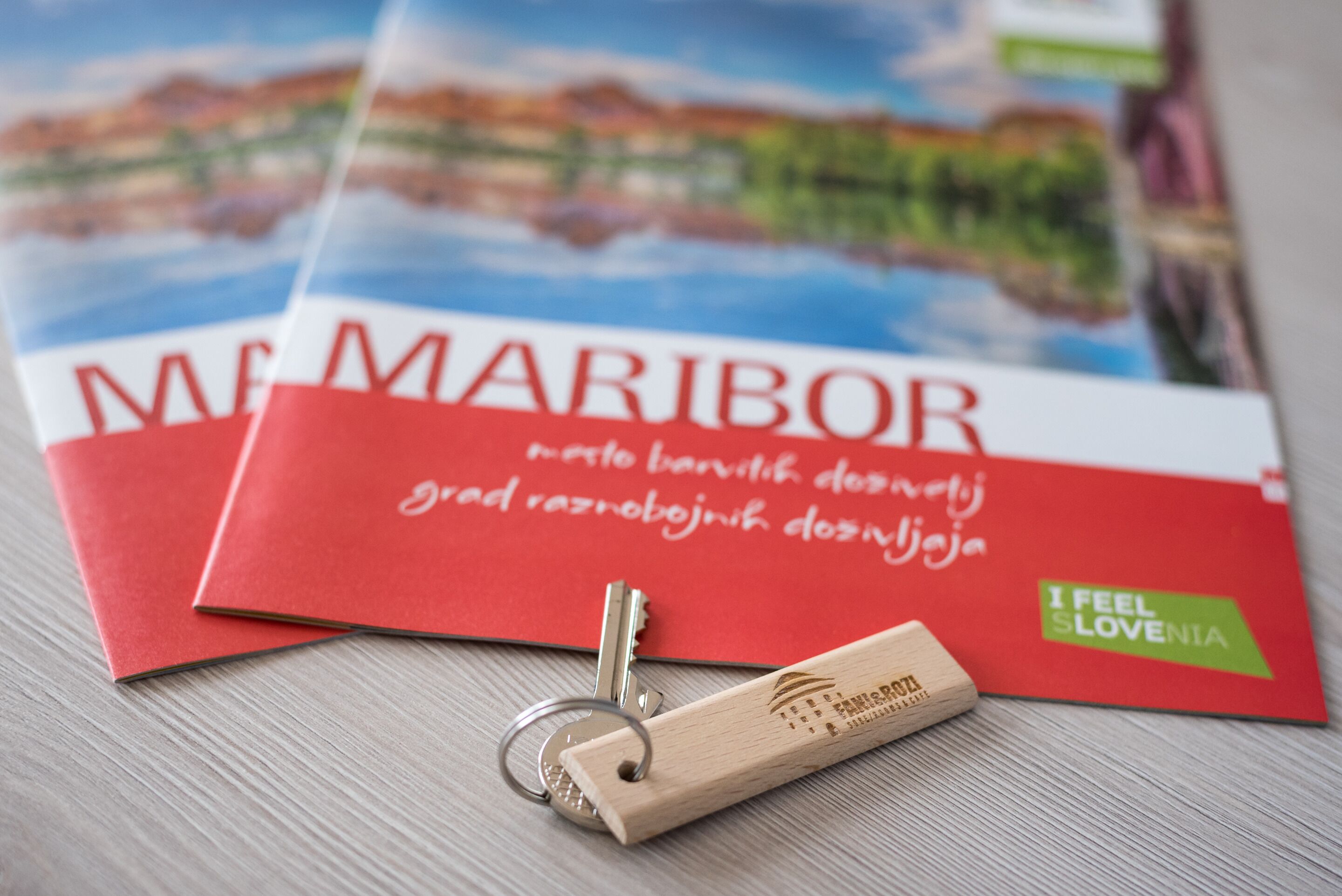 A set of red envelopes with text and a wooden keychain with text.
