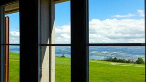 A view through a window with a clear sky, a green field, and a distant landscape. - Stunning private villa for 6 people with WIFI, pets allowed and panoramic view (Les Cluds)