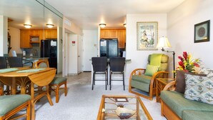 A compact living space with a dining area, kitchen, and seating area.
