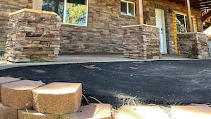 A two-story building with a wooden balcony, stone foundation, and a stone chimney. - Bryce & Zion midpoint!  Firepit & pool table. ATV trails nearby. (Alton)