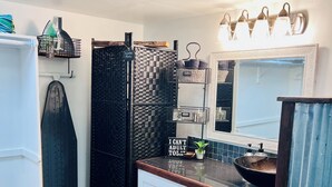 A kitchen with white cabinets, a black backsplash, and a wooden countertop. There are hanging lights above the sink and a black refrigerator. - Private & Cozy cabin with Hot Tub-Coffee Bar-Cowboy Pool (Hot Springs)