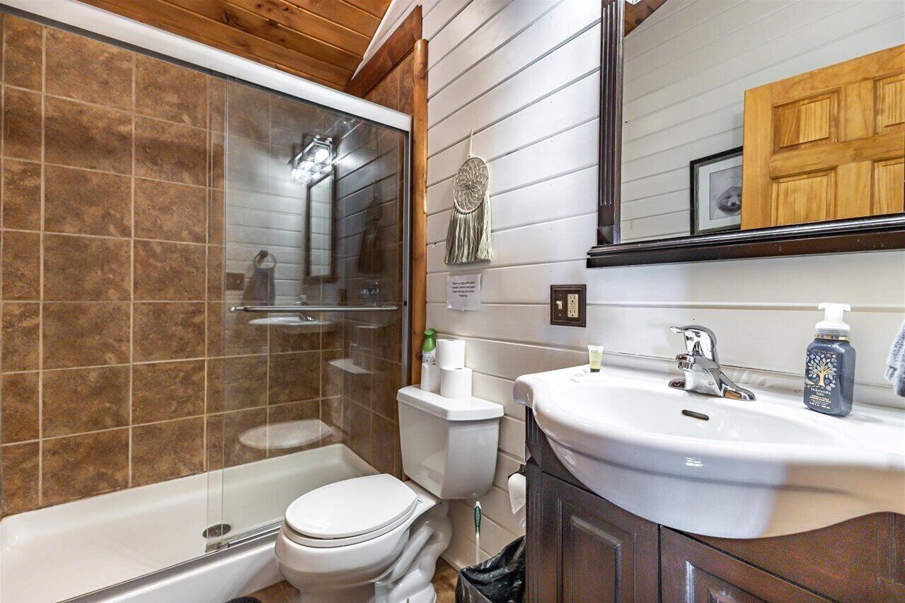 A bathroom with a bathtub, toilet, and sink.