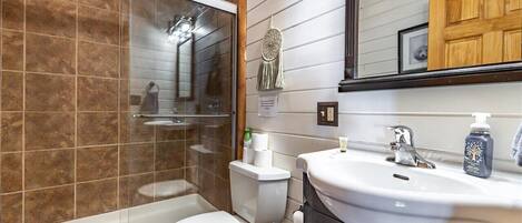 A bathroom with a bathtub, toilet, and sink.