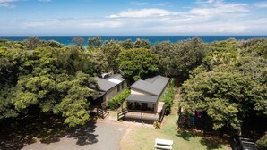 A two-story house with a large deck and a view of the ocean. - Tiona Palms Holiday Park (Tiona)