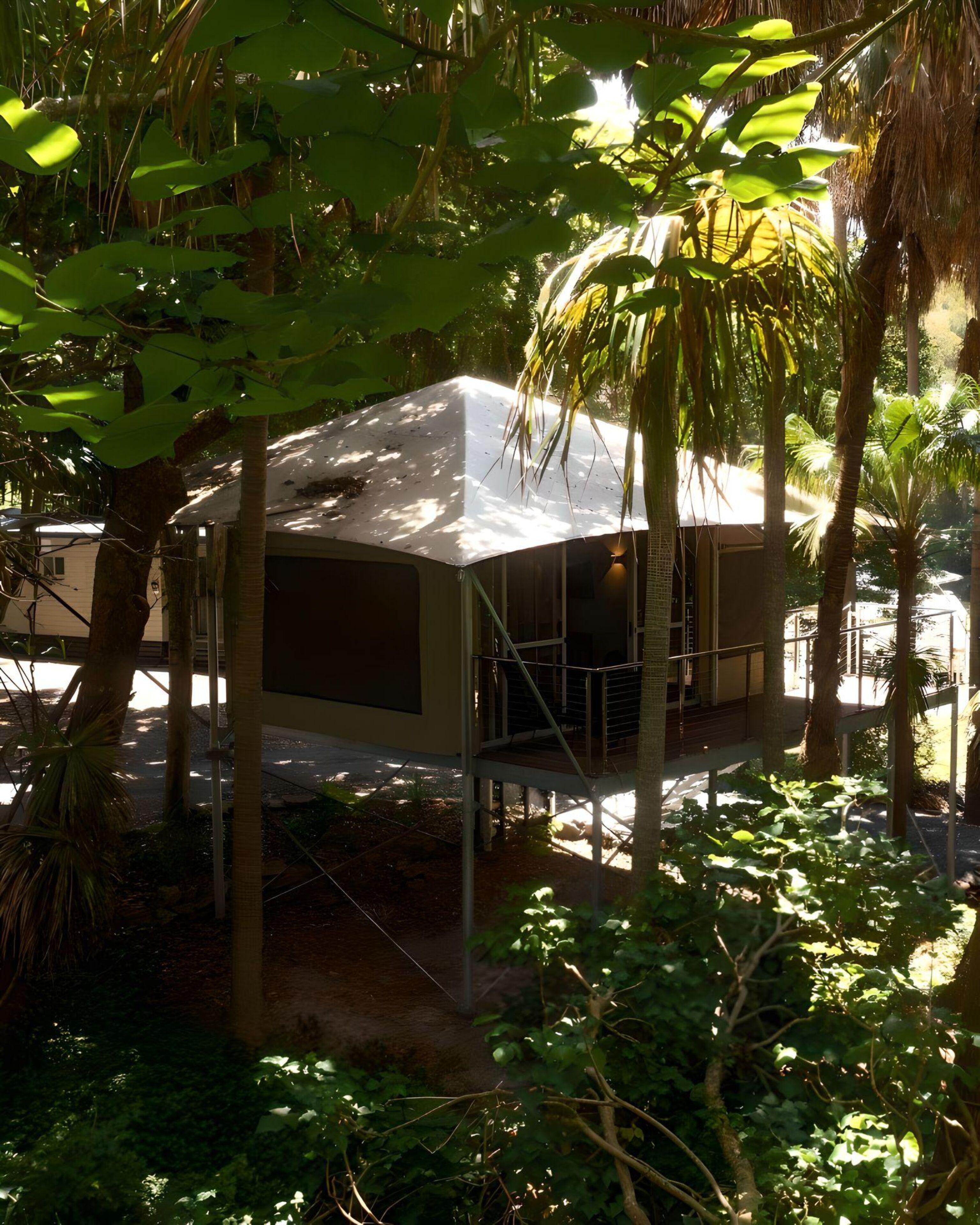 A modern, single-story building with a flat roof, surrounded by dense tropical foliage.