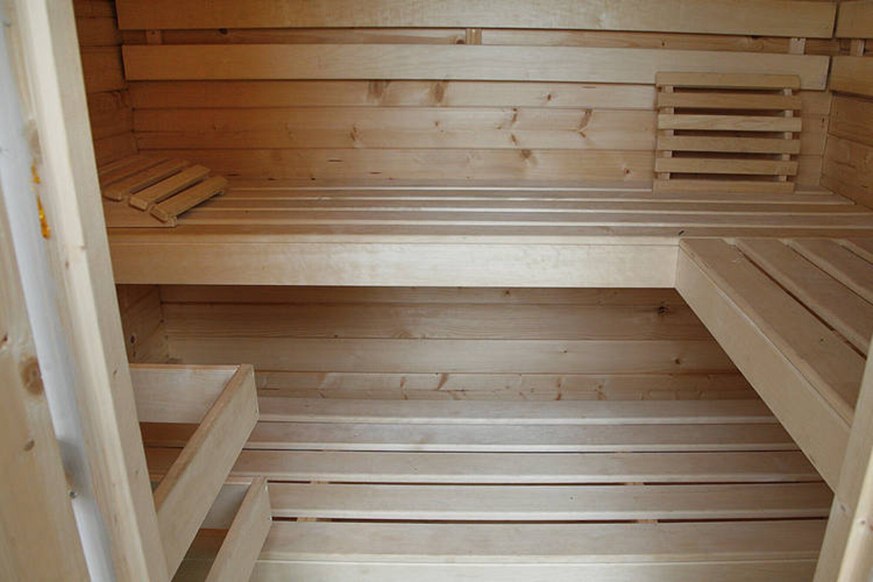A sauna with wooden benches and benches.