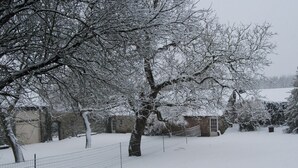 A snow-covered outdoor area with a stone wall and a wire fence. - Stone-built Holiday Home in Dinant With Terrace (Dinant)