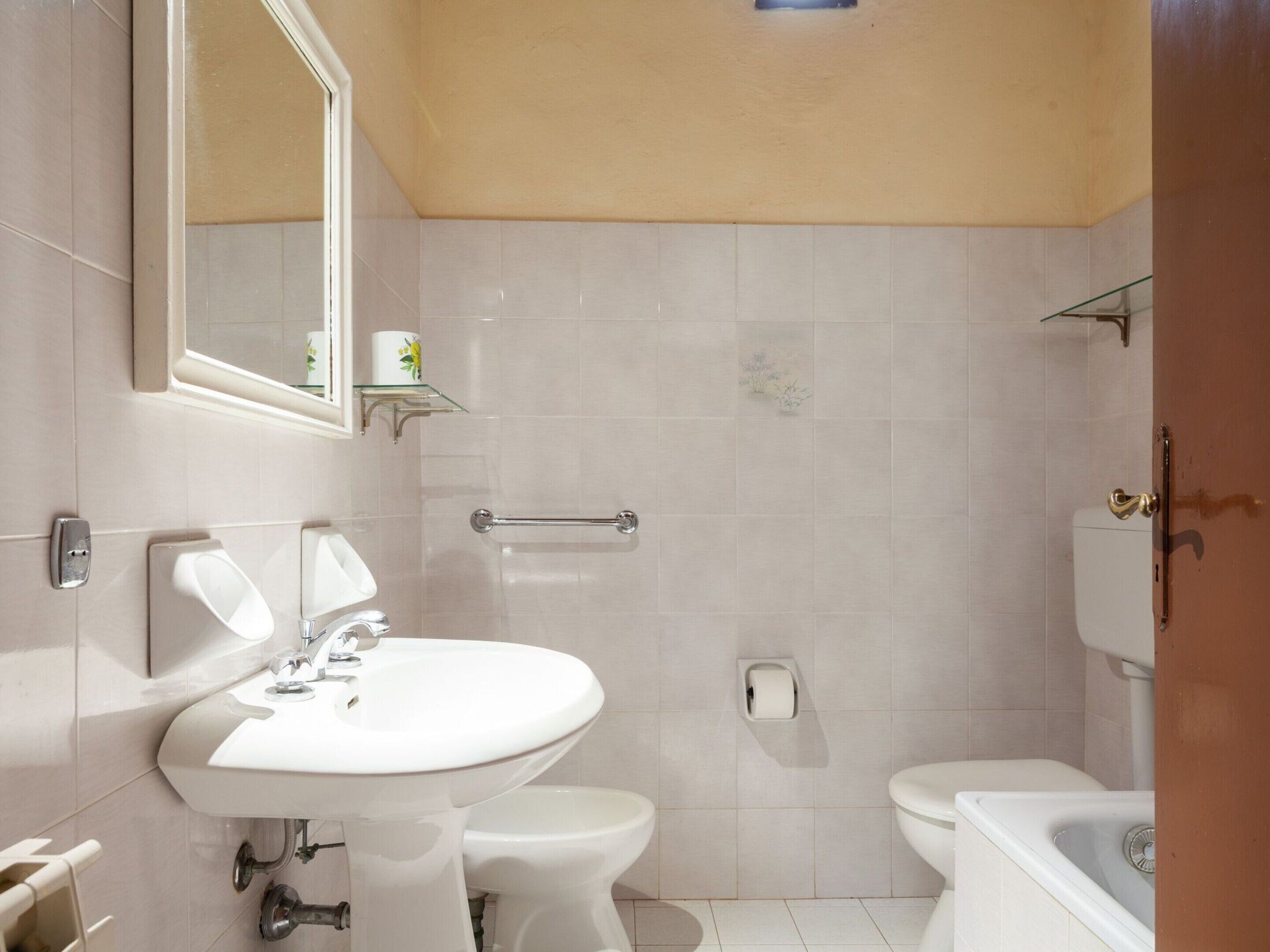 A bathroom with a sink, toilet, and bathtub.