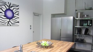 A modern kitchen with stainless steel appliances, a wooden countertop, and a fruit bowl. - Luxurious Countryside Holiday Home With Pool (Malmedy)