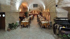 A restaurant with a vaulted ceiling, multiple tables and chairs, and a bar area. - Farm Near the Beautiful Ionian Sea, in the Beautiful Salento (Torricella)