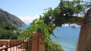 A staircase leading to a terrace with a view of the sea and a mountainous landscape. - Mansion in Capo Vaticano With Sea Views (Ricadi)
