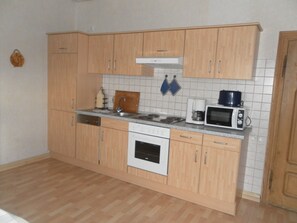Enjoy cooking in this well-equipped kitchen with a stove, oven, microwave, and coffee maker.
