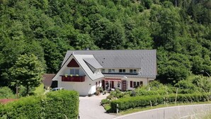 A two-story building with a sloped roof, surrounded by dense forest. - Holiday Home Near the Forest in Oppenau (Oppenau)