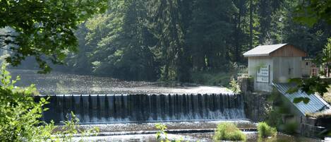 A waterfall with a small building nearby.