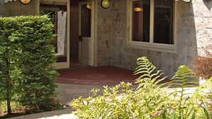 A building with a stone facade and a white awning that reads "Residence Garden." - Belvilla by OYO Bilo Garden Due Bis (Cannobio)