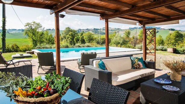 An outdoor patio with wicker furniture, a pool, and a view of the countryside. - Magnificent old Country House With Garden and Private Pool, With Wifi (Salsomaggiore Terme)