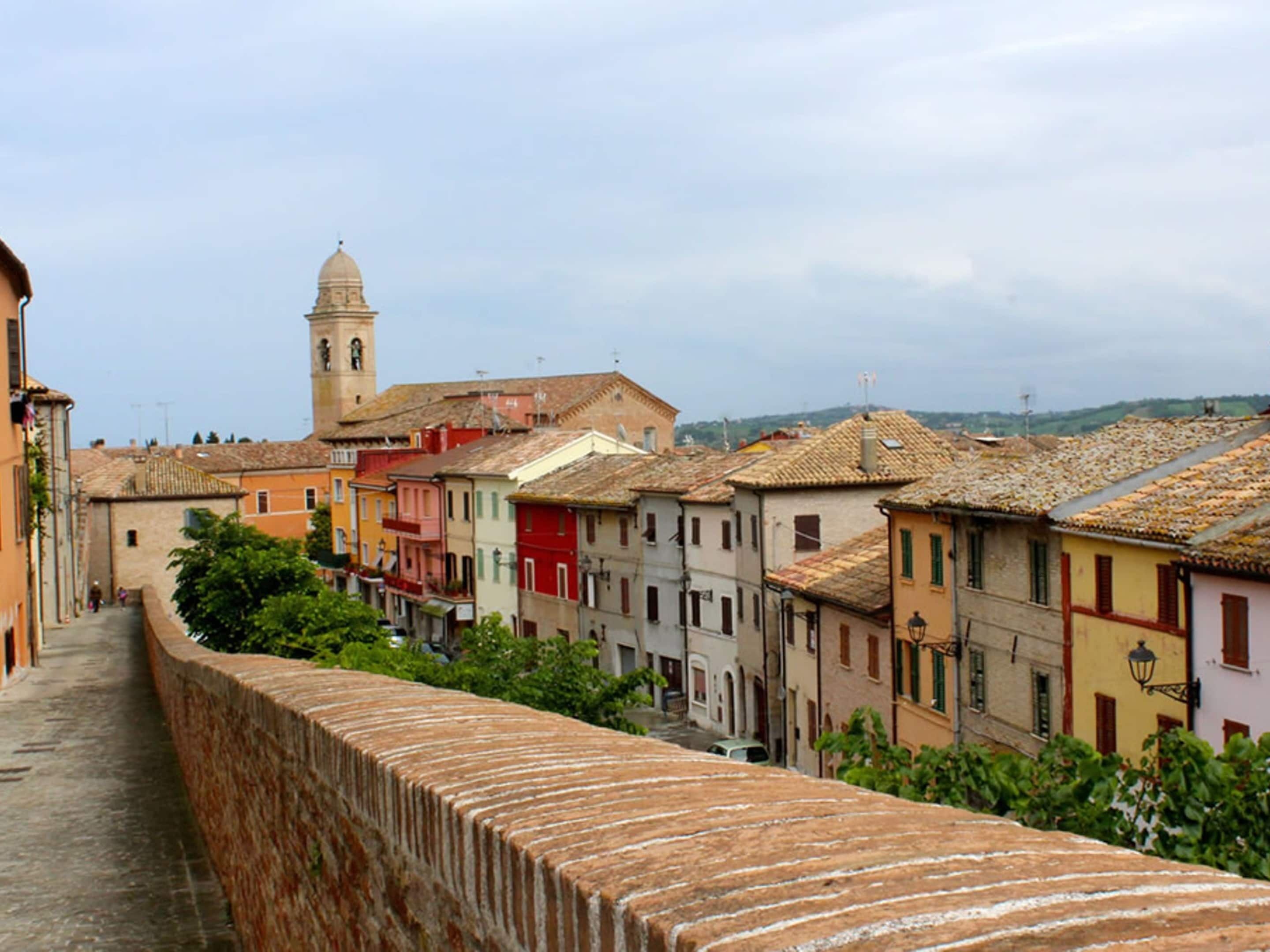 A historic town with colorful buildings and a prominent tower.