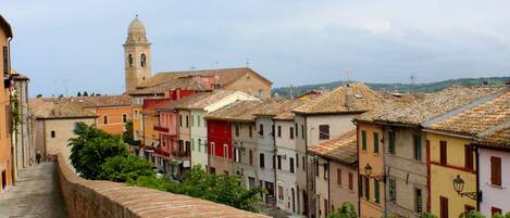 A historic town with colorful buildings and a prominent tower.