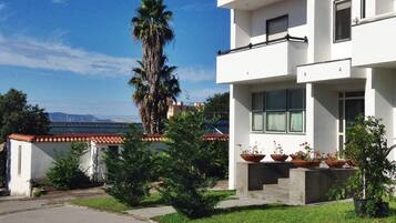 Un edificio moderno a due piani con tetto piatto, ampie finestre e un balcone.