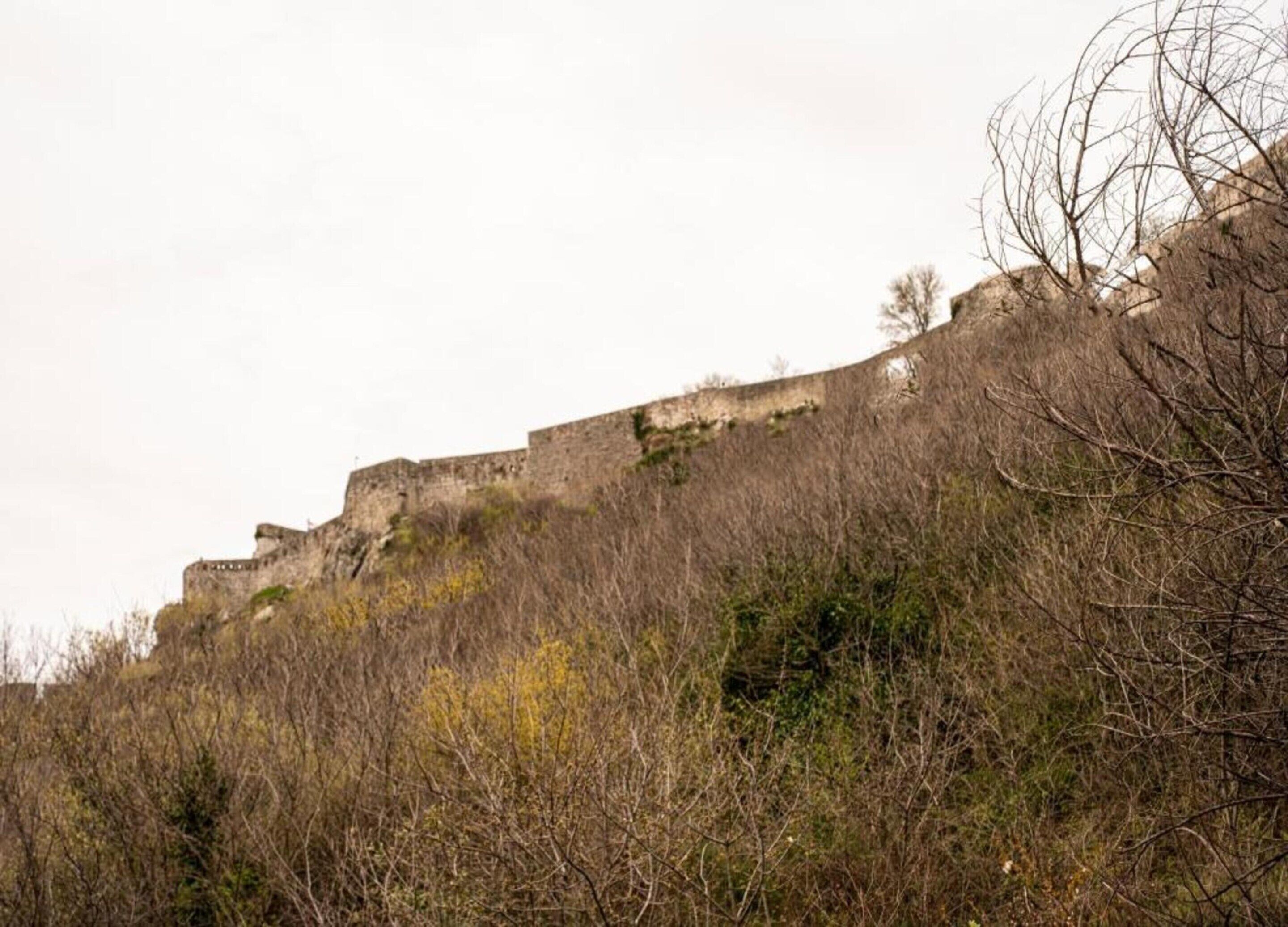 A historic fortification with multiple levels and a rugged terrain.