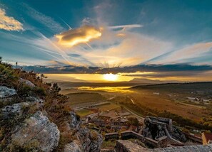 Explore a serene landscape with a historic stone structure and rolling hills.