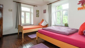 A bedroom with two beds, wooden flooring, and large windows. - Farm With Lovely Panoramic Views (Trois-Ponts)