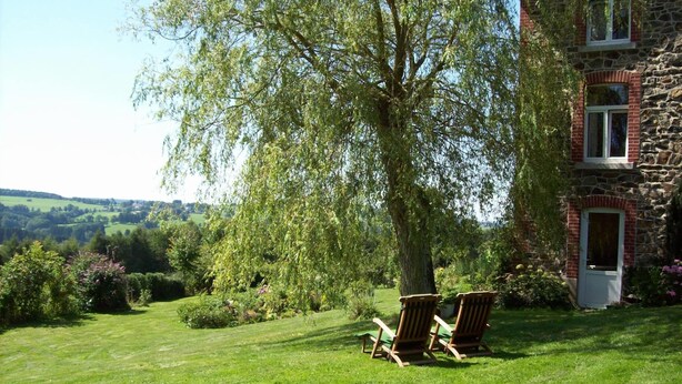 A stone building with a door and windows, a grassy lawn, and two wooden chairs. - Farm With Lovely Panoramic Views (Trois-Ponts)