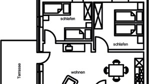Un plan d’étage comprenant une terrasse, deux chambres, un salon, un coin repas, une cuisine, une salle de bain et une soufflerie aérodynamique.