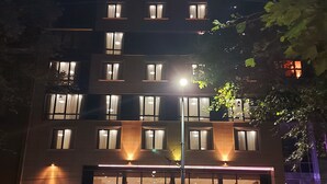 A hotel with a modern facade, large windows, and a prominent sign for 'pulcin coop hotel'. - Hotel Puldin COOP (Plovdiv)
