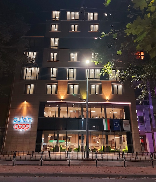 A hotel with a modern facade, large windows, and a prominent sign for 'pulcin coop hotel'. - Hotel Puldin COOP (Plovdiv)
