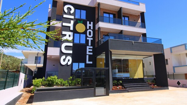 A modern hotel with a prominent sign reading "CITRUS HOTEL". - Hotel Citrus (Ksamil)